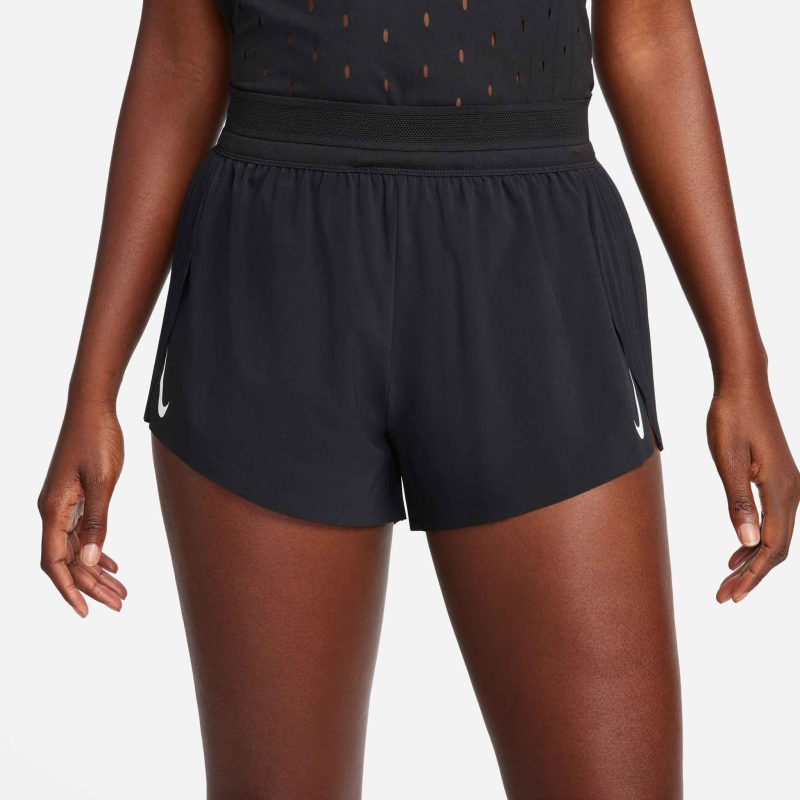 Front view of a model wearing a pair of Nike Women's AeroSwift Dri-FIT ADV Mid-Rise Brief-Lined 3" Running Shorts in the Black/White colourway. Model is also wearing a top. (8399137964194)